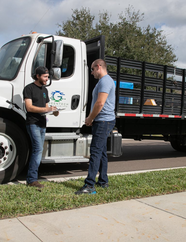 Greentech Renewables Employee Delivering Solar Panels