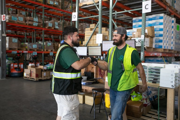 Greentech Renewables teammates working in warehouse.