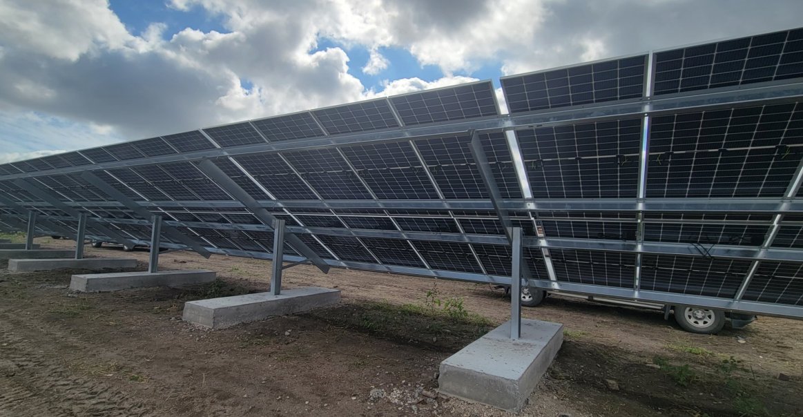 View of backsheets in solar panel ground mount array commercial project.