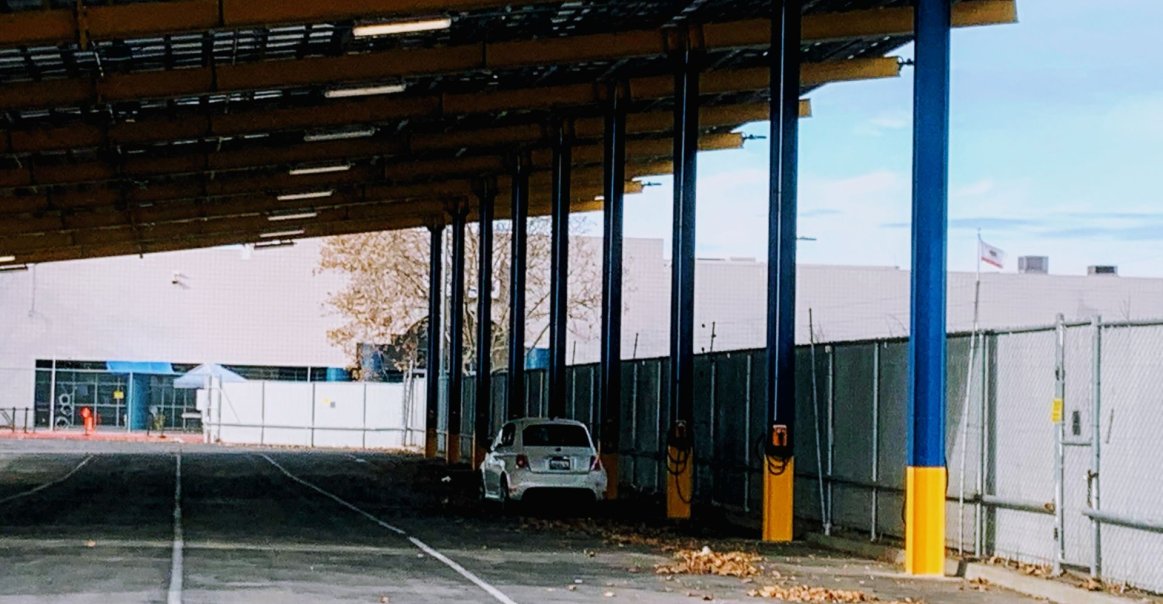 Car Charging Under the Solar Car Port Once Construction Was Completed.