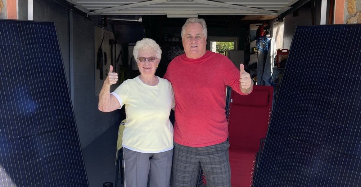 Solar Installer's Parents Pose with Solar Panels