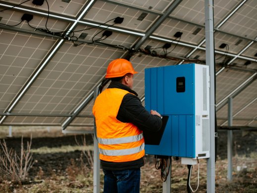 Solar installer checking solar battery bank.